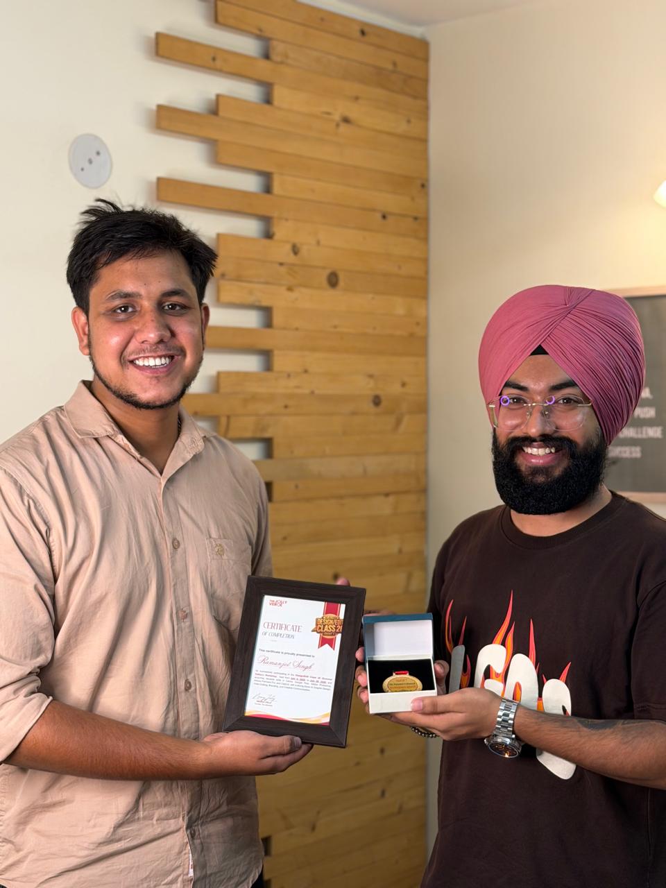 Student receiving certificate and medal at The Jollyverse studio