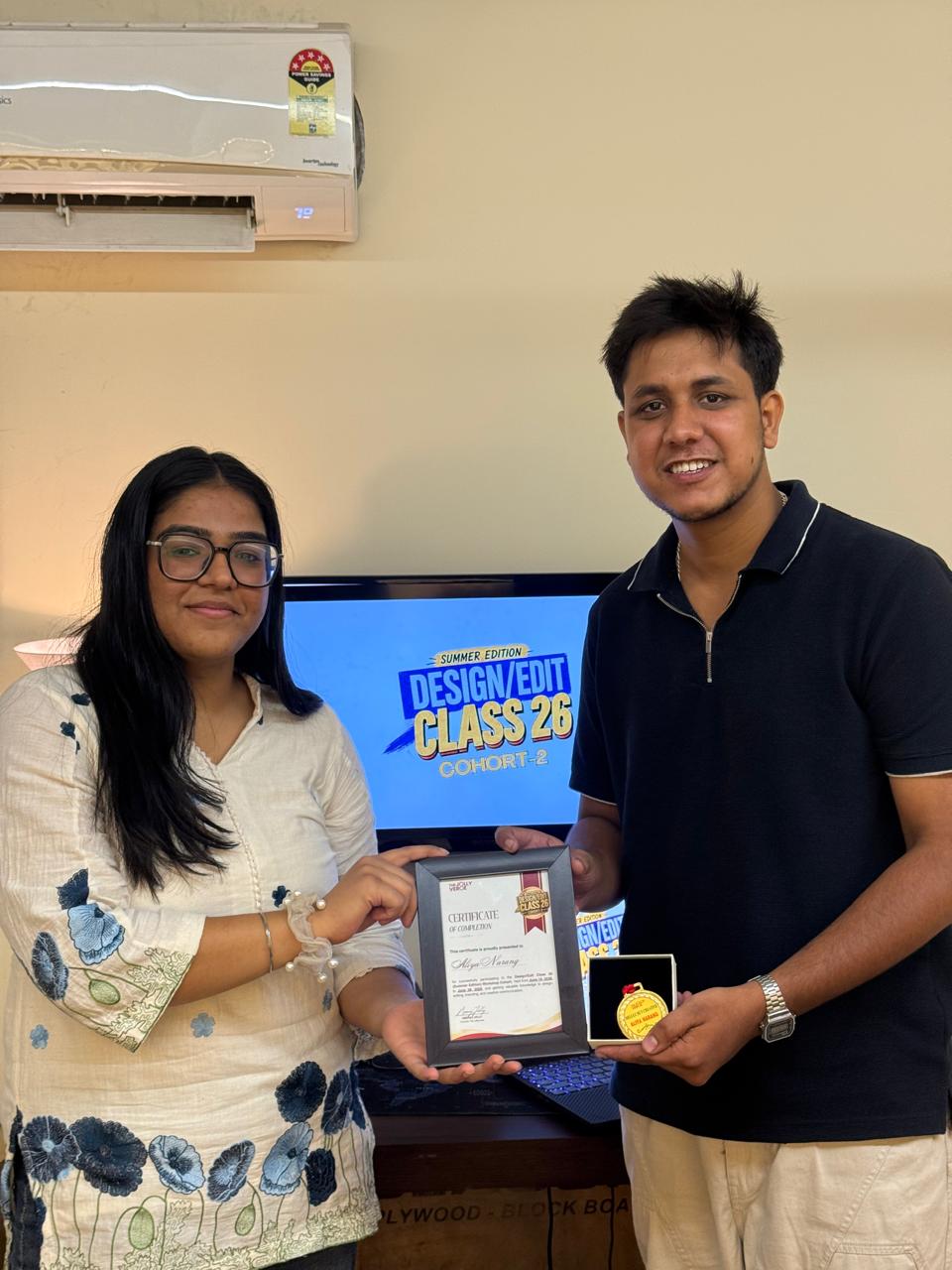 Student receiving certificate and medal for Cohort 2