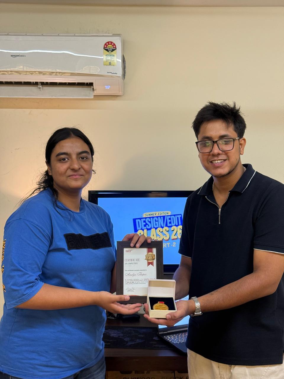 Student holding her certificate and medal after the cohort