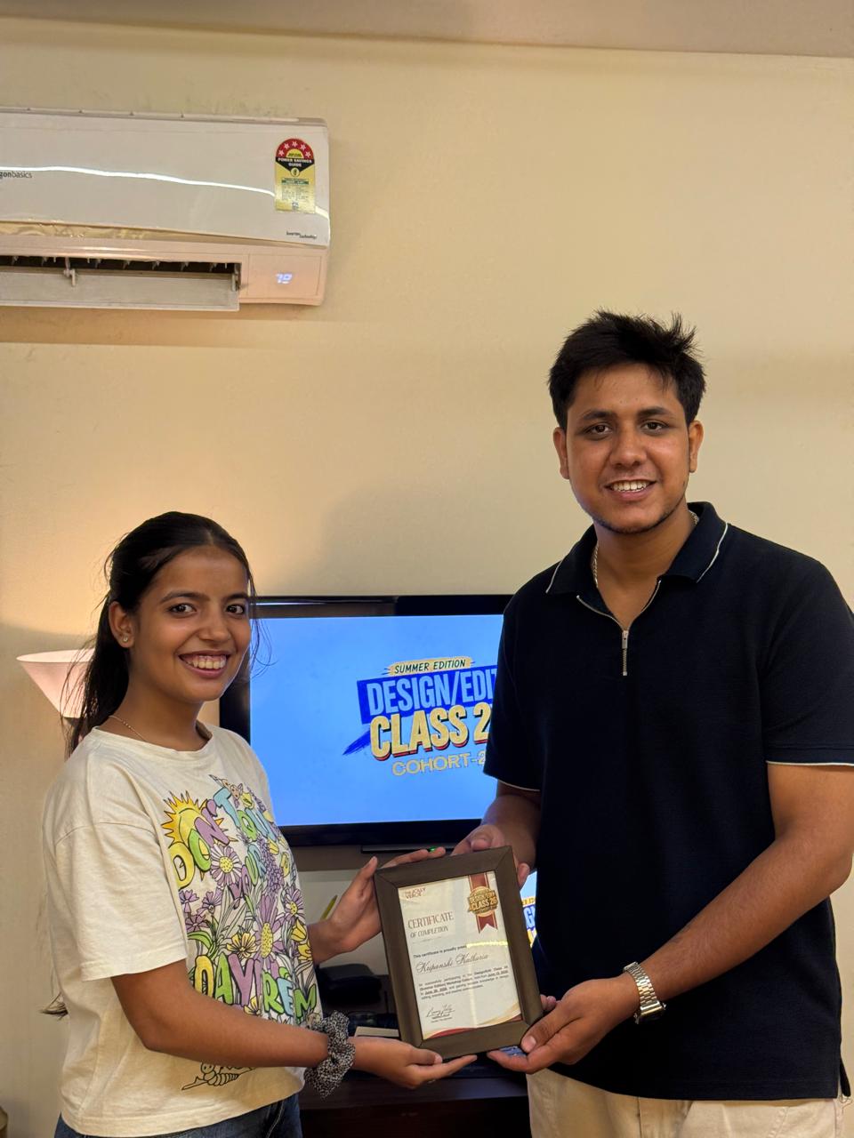 Cohort 2 student with her framed completion certificate