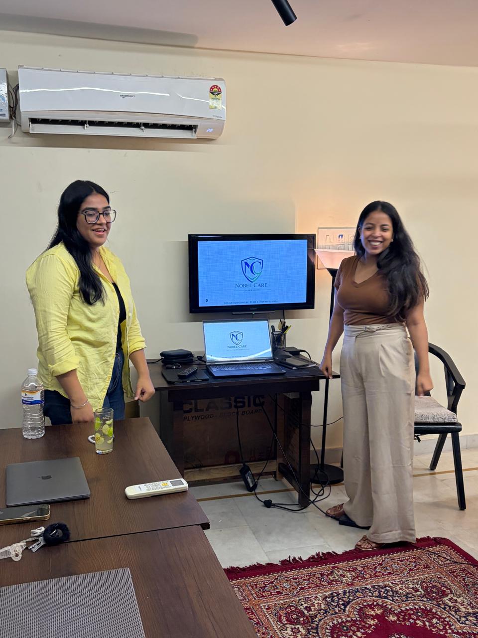 Students presenting a brand identity project on screen
